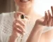 depositphotos 150318200 stock photo woman with bottle of perfume
